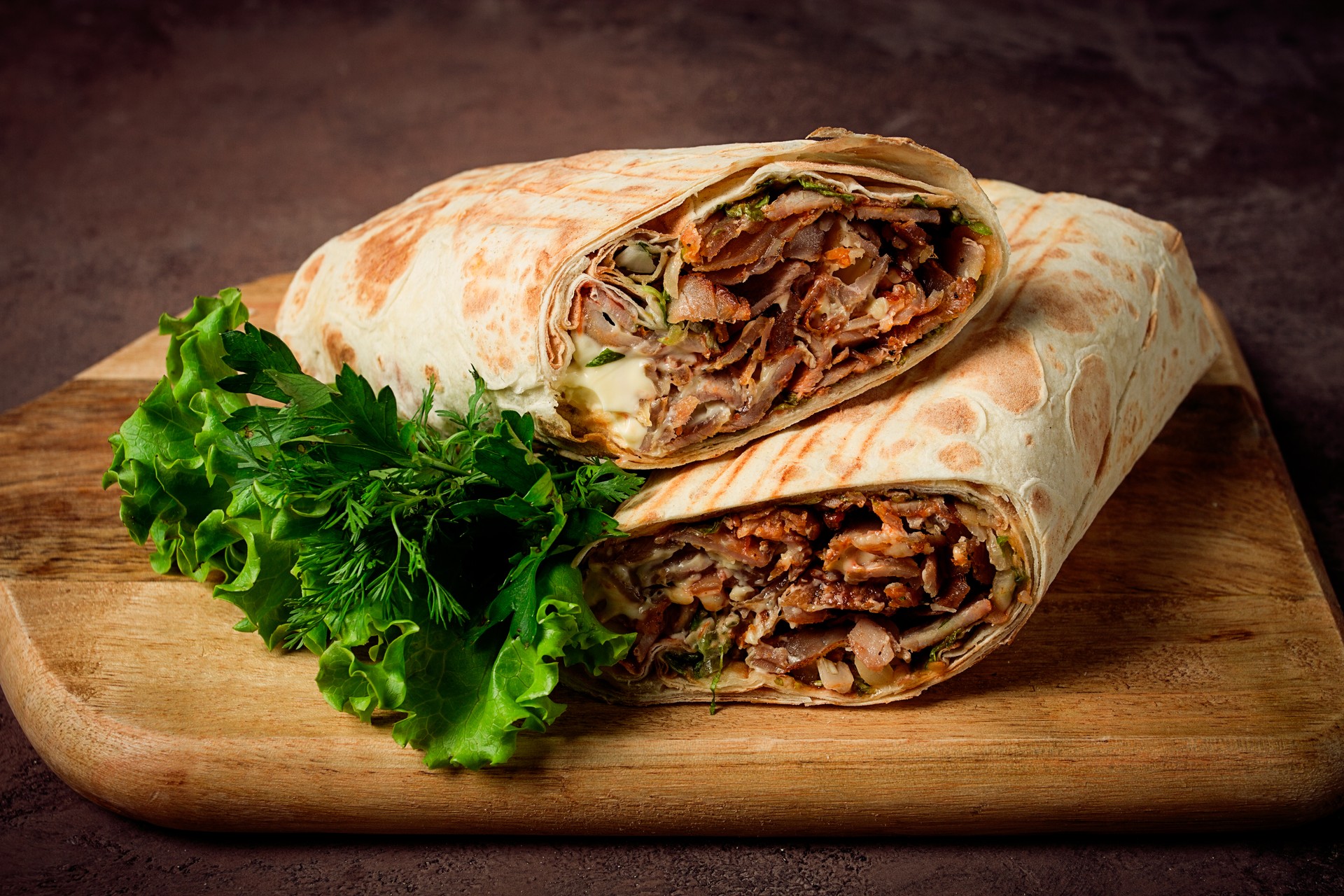 cut shawarma, 2 pieces, on a cutting board, close-up,